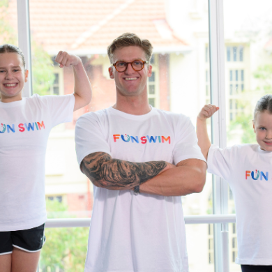 A man and two children smiling for a photo