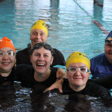 Women and Coaches In the pool as part of the splash together program 