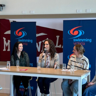 4 women sitting behind a desk